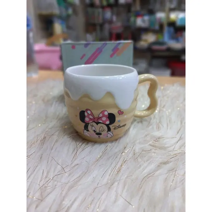 A uniquely designed porcelain mug in light beige with a raised embossed design