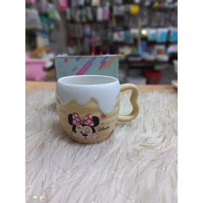 A uniquely designed porcelain mug in light beige with a raised embossed design